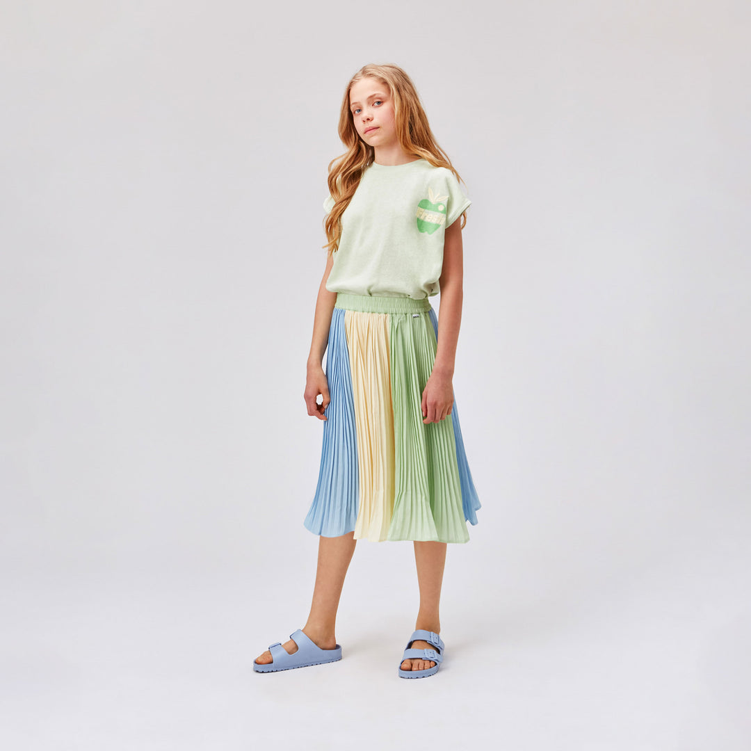 MOLO - Girl in Pale Green Top and Pleated Skirt