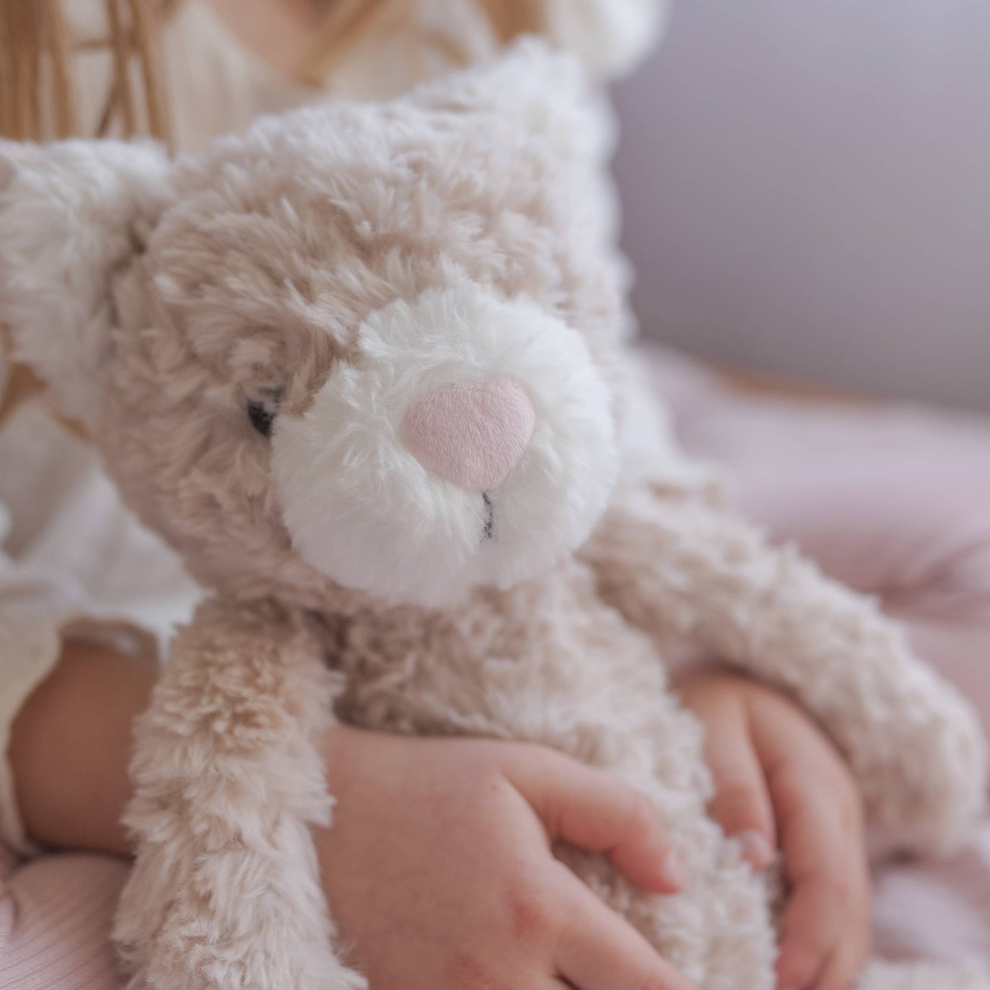 Child holding weights cat plush toy