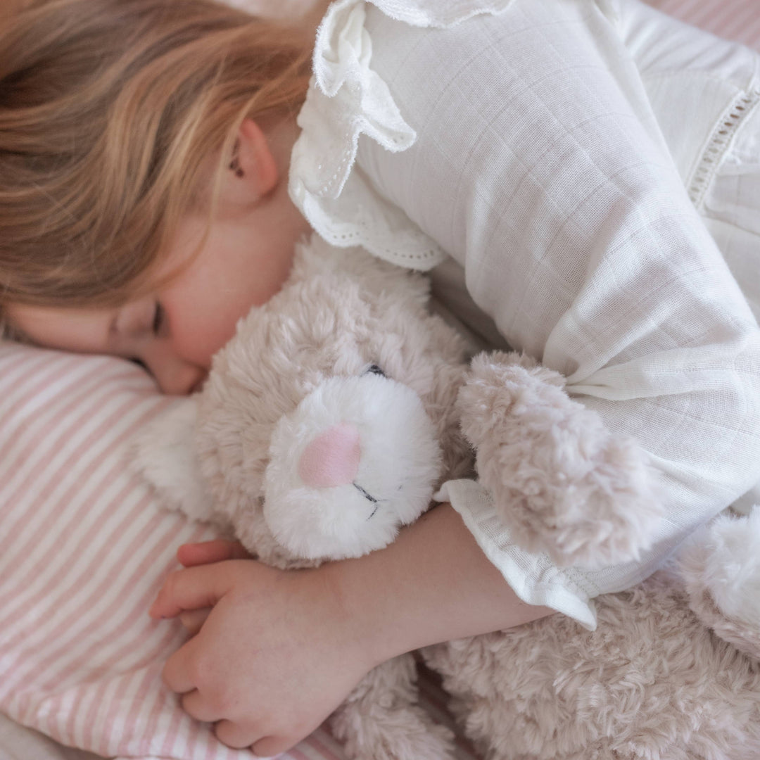 Child sleeping with weighted plush toy