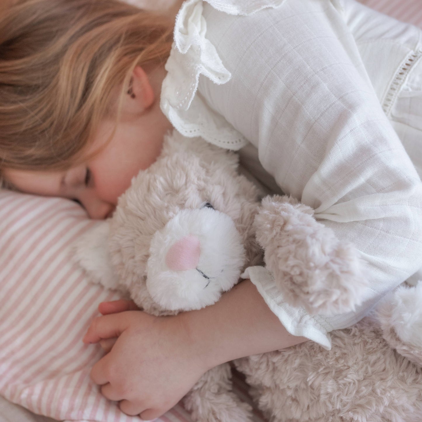 Child sleeping with weighted plush toy