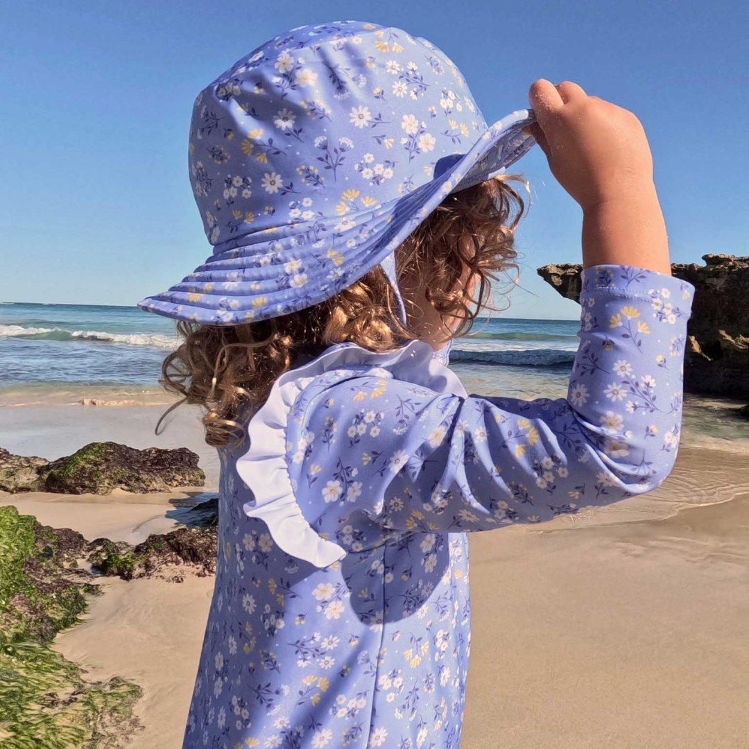 Pure Baby - Girl at the beach with swimmers and matching broad brim hat in daisy print