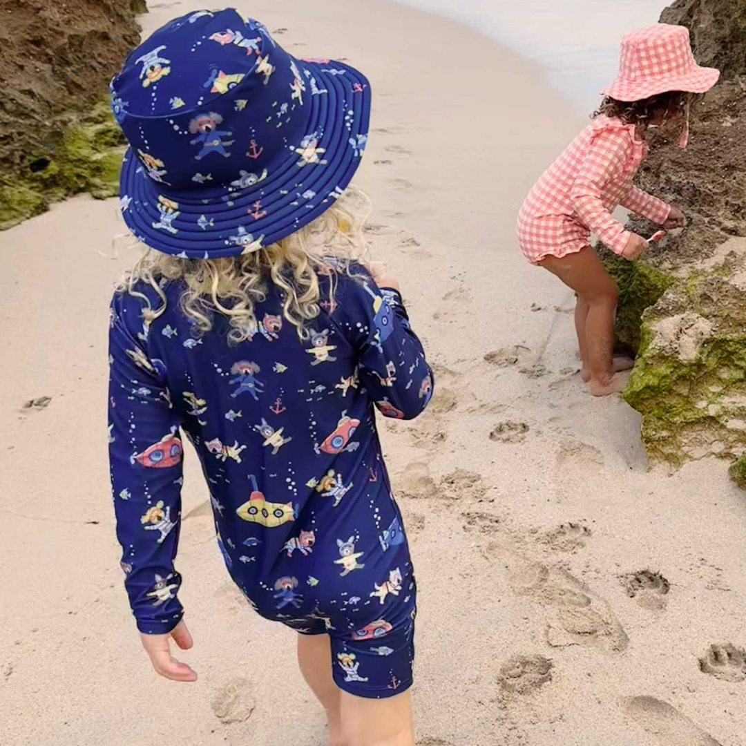 Pure Baby - Children at the beach in swimsuit and matching swim hat