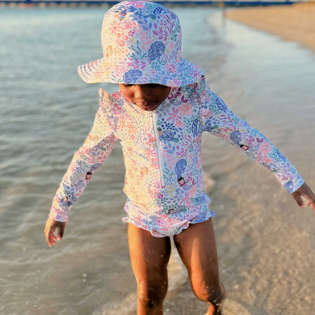 Pure Baby - Girl playing in the ocean with swimsuit and matching swim hat