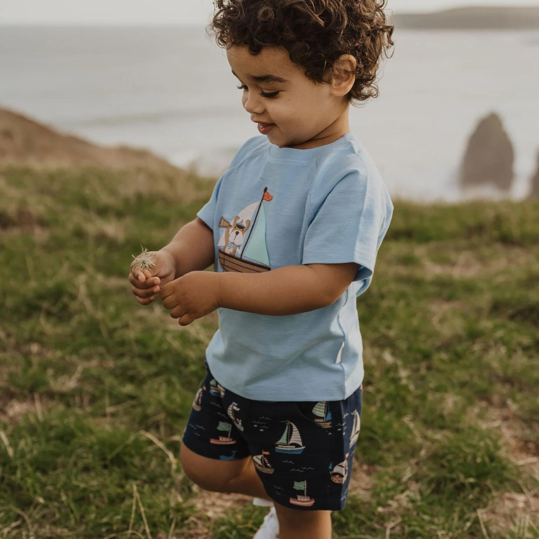 Pure Baby - Toddler on the grass wearing top and shorts