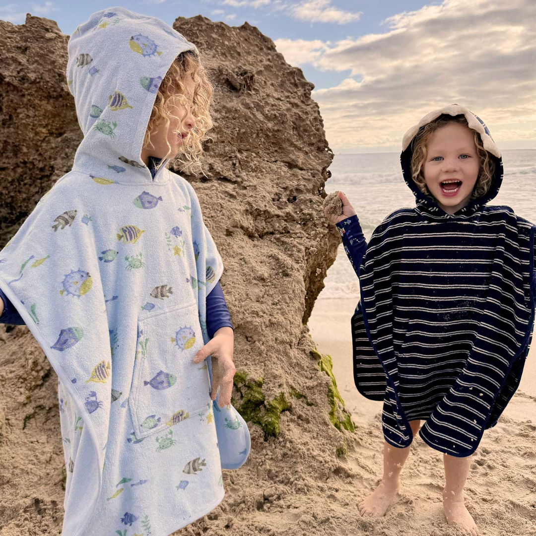 Pure Baby - Two children at the beach with towel ponchos