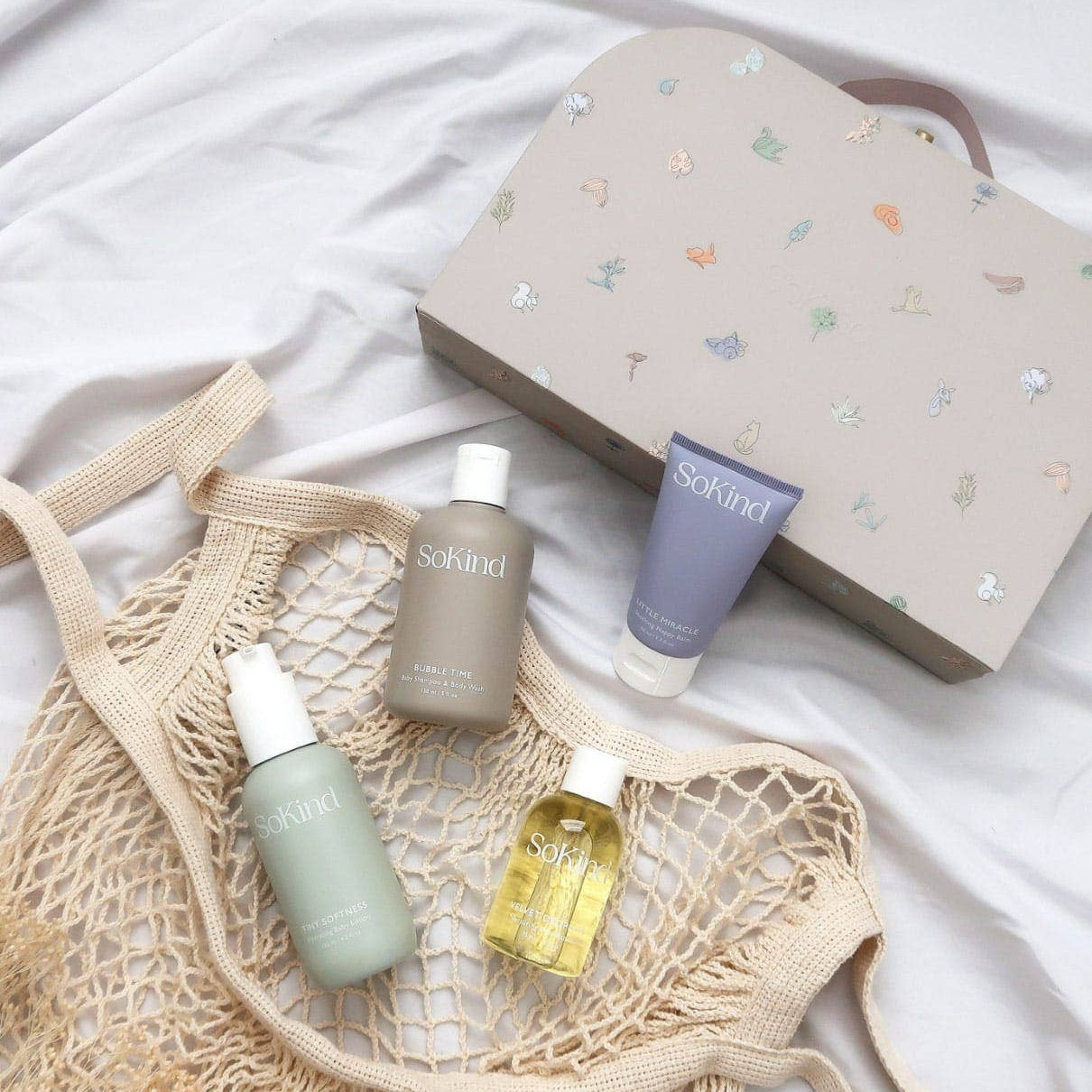 Skincare products and a net bag on a white background